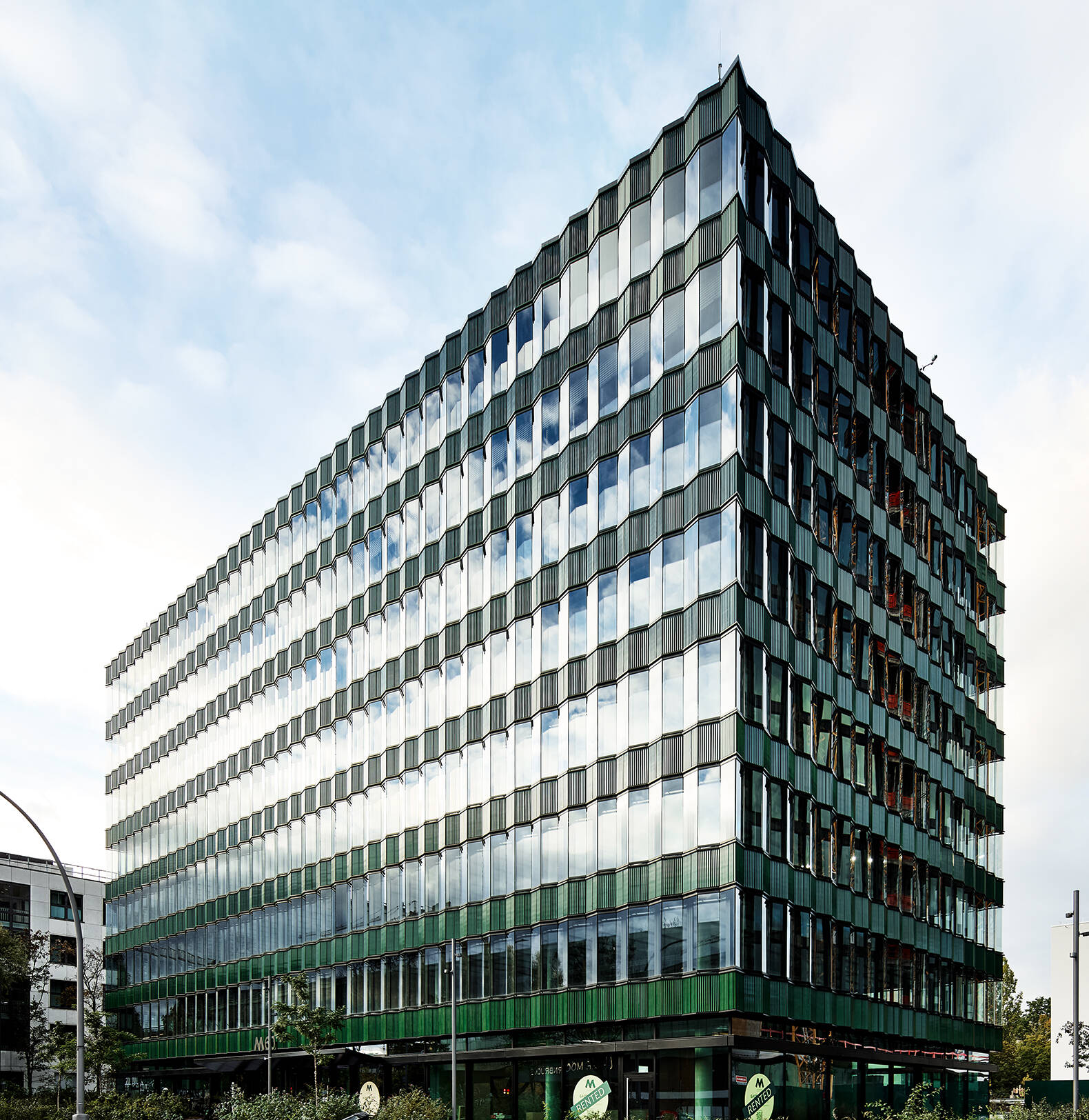 A modern brick building at Die Macherei Berlin featuring expansive ISOLAR glass facades that blend industrial heritage with contemporary design.