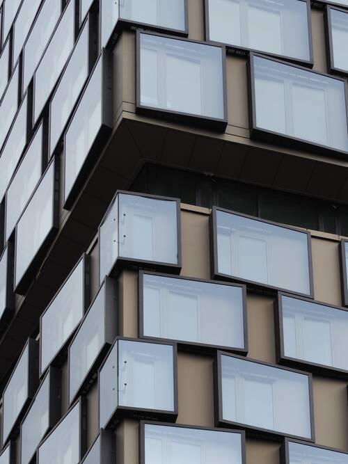 Modern architecture featuring SOLARLUX sunlite grey 65 solar control glazing for optimized energy efficiency and natural light.