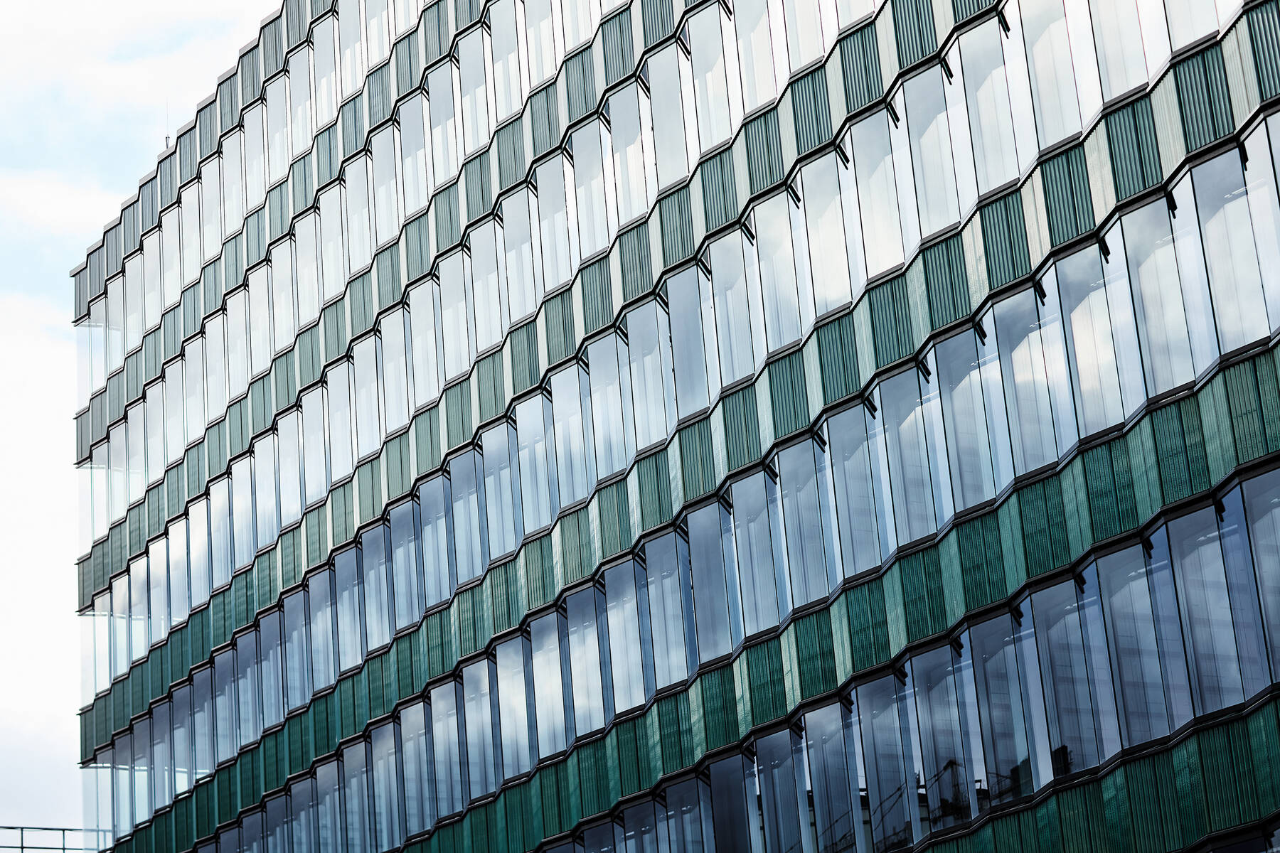 Close-up of the large-scale window fronts at Die Macherei, showcasing the high transparency and sound insulation of the ISOLAR glass units.
